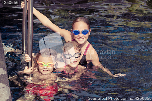 Image of happy children  playing on the swimming pool