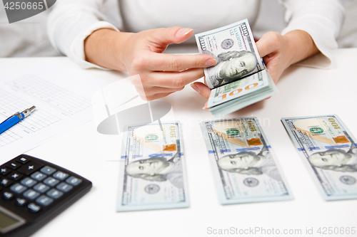 Image of Hands counting money, close up