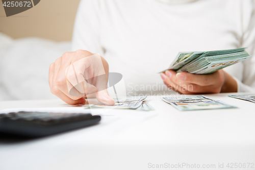 Image of Hands counting money, close up