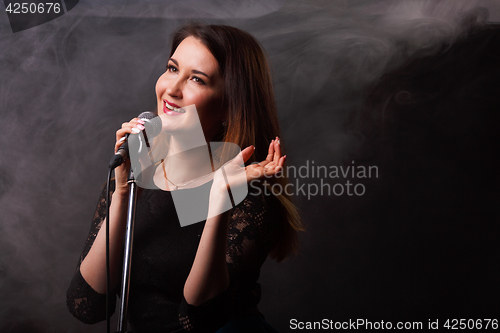 Image of Singing woman on smoke background