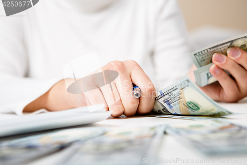 Image of Hands counting money, close up