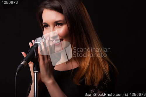 Image of Woman with microphone in hands