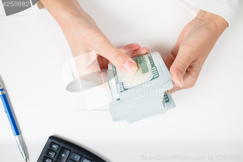 Image of Female hands counting money,