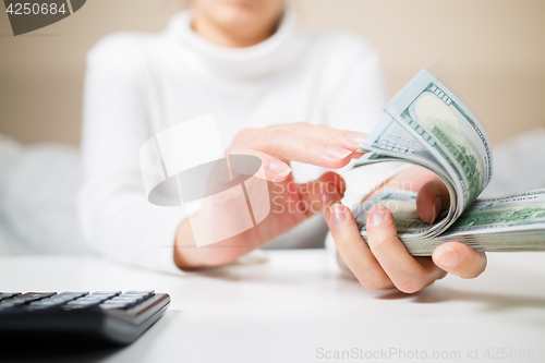 Image of Woman countring money.