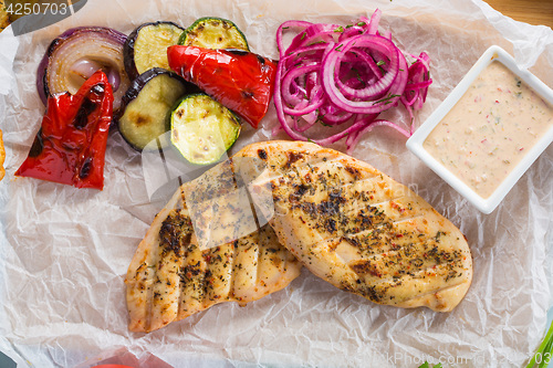 Image of Grilled chicken breast with fries and salad