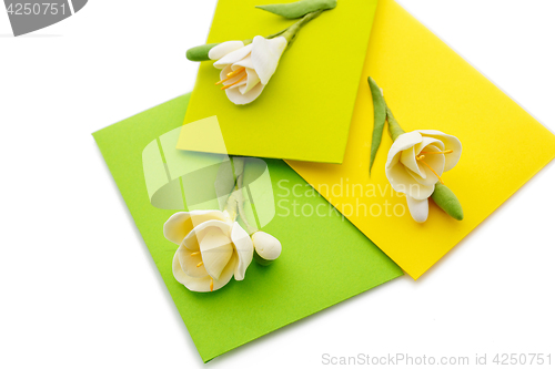 Image of Close up of three yellow envelope with flowers