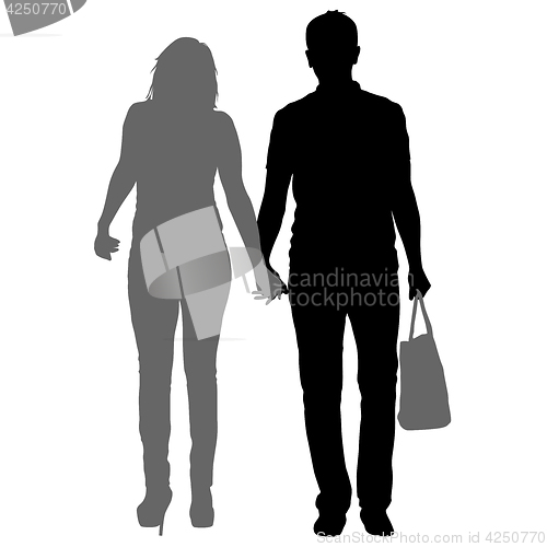 Image of Silhouette man and woman walking hand in hand