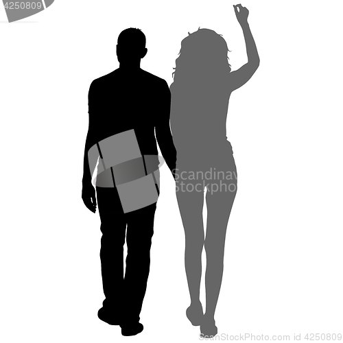 Image of Silhouette man and woman walking hand in hand
