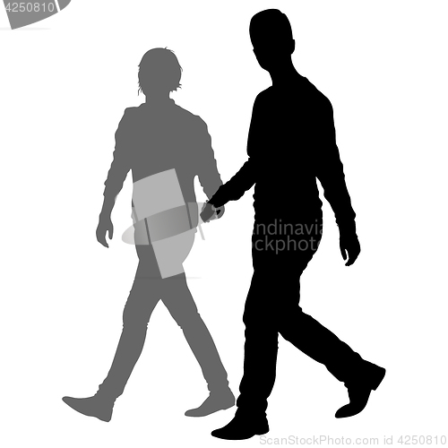 Image of Silhouette man and woman walking hand in hand