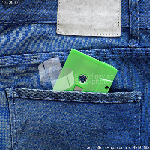Image of Green cassette tape in a pocket