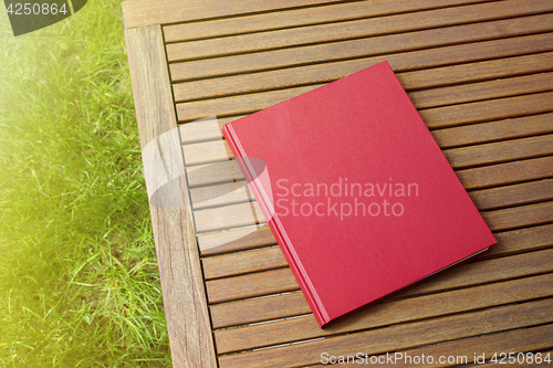 Image of Red book on the outdoor table at coffee shop