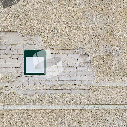 Image of brick wall and metal plate