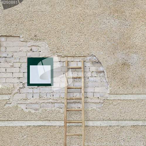 Image of brick wall and metal plate