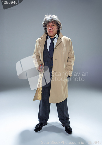 Image of Senior police agent with a gun on dark smoke background