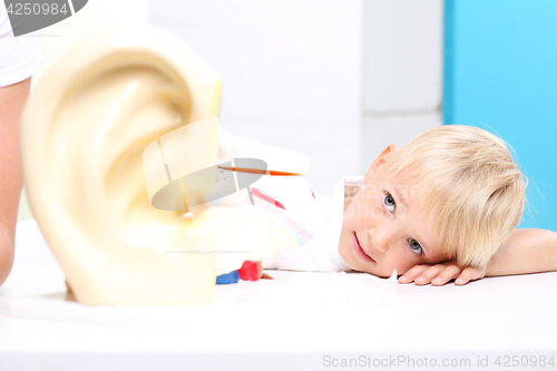 Image of Students anatomy lesson. Children watch a model of the human ear.