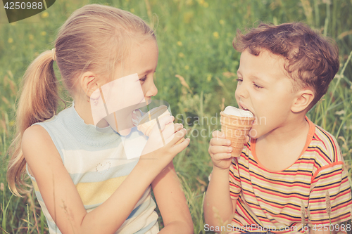 Image of Two happy children  playing in park