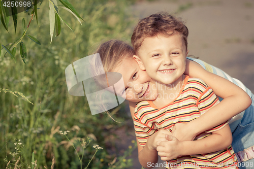 Image of Two happy children  playing in park