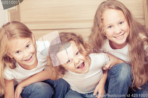 Image of Portrait of happy children which are sitting on the stairs in th