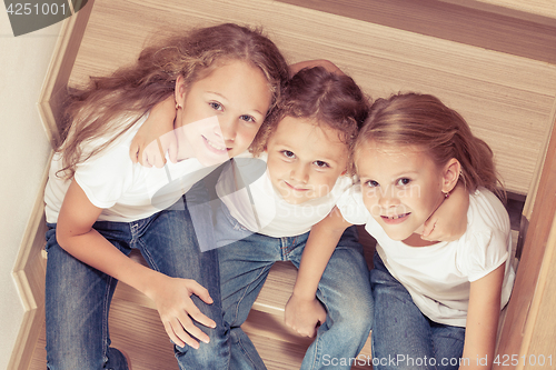 Image of Portrait of happy children which are sitting on the stairs in th