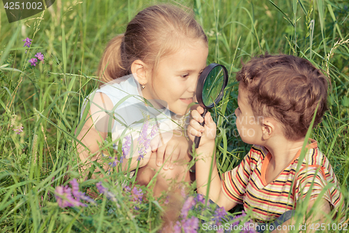 Image of Two happy children  playing in park