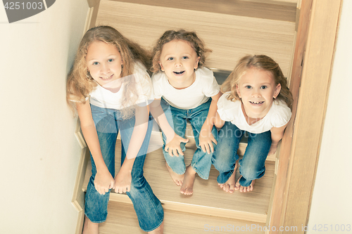 Image of Portrait of happy children which are sitting on the stairs in th