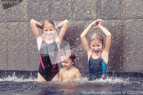 Image of happy children  playing on the swimming pool