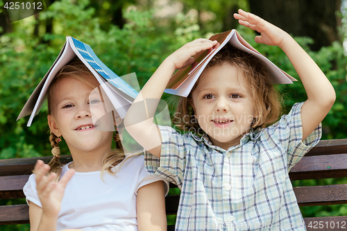 Image of Three happy children  playing in park