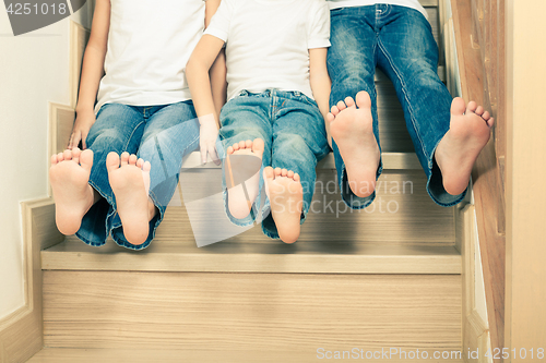 Image of Portrait of happy children which are sitting on the stairs in th