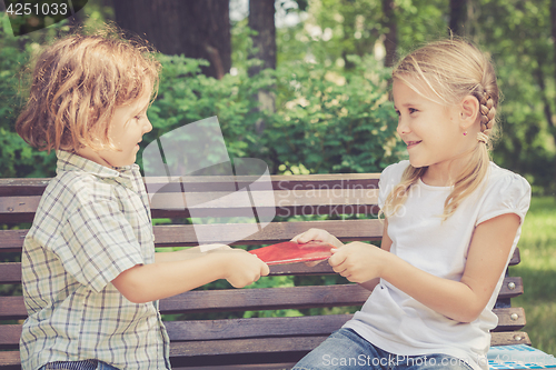 Image of Two happy children  playing in park