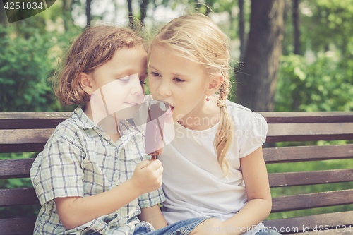 Image of Two happy children  playing in the park at the day time. 