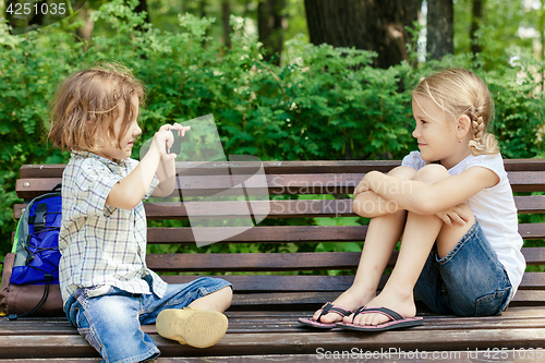 Image of Two happy children  playing in park