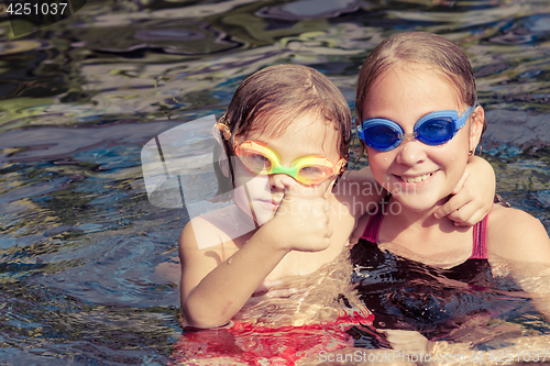 Image of  happy children  playing on the swimming pool