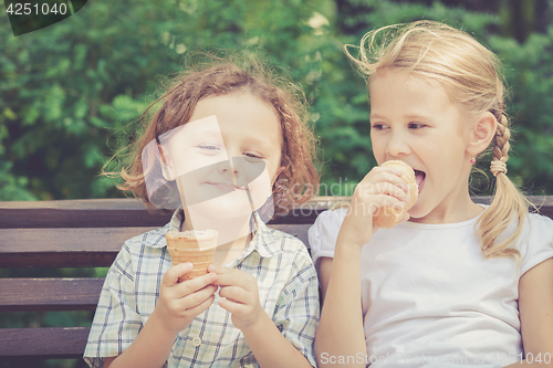 Image of Two happy children  playing in the park at the day time.