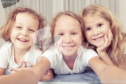 Image of Portrait of happy children which are lying on the floor in the h