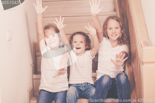 Image of Portrait of happy children which are sitting on the stairs in th