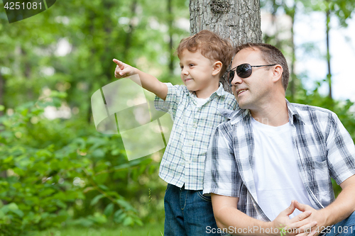 Image of Father and son playing in the park at the day time.