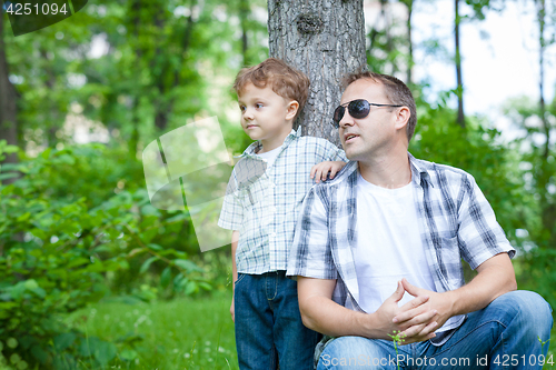 Image of Father and son playing in the park at the day time.