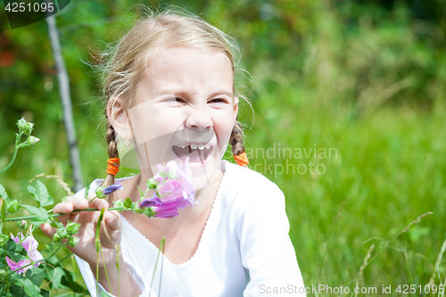 Image of portrait of a beautiful young girl with wildflowers 