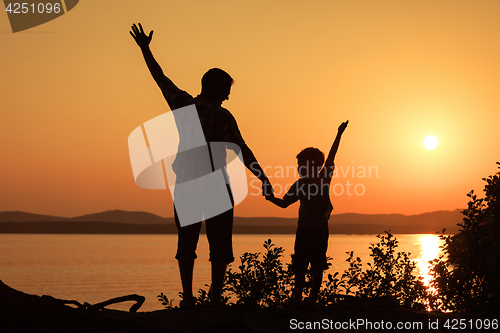 Image of father and son playing on the coast of lake