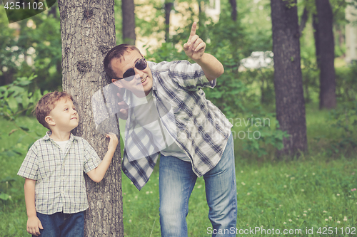 Image of Father and son playing in the park at the day time.