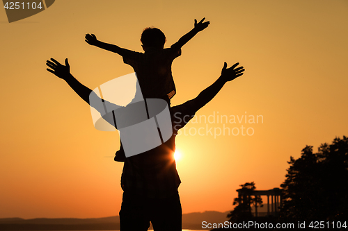 Image of father and son playing on the coast of lake