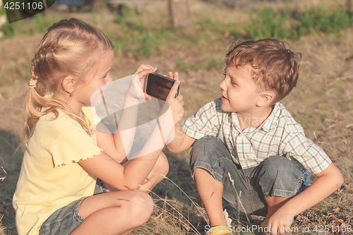 Image of Two happy children  playing in park