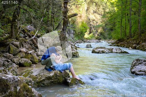 Image of The girl with guy at the river