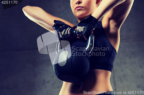 Image of close up of woman with kettlebell in gym