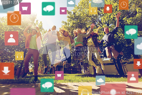 Image of happy teenage students or friends jumping outdoors