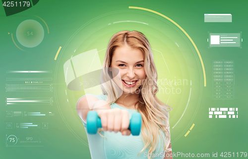 Image of smiling beautiful young sporty woman with dumbbell