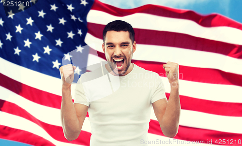 Image of angry man showing fists over american flag