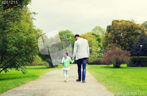 Image of happy family walking in summer park