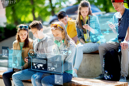 Image of teenage friends with smartphones outdoors