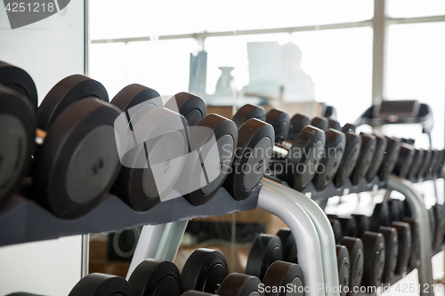 Image of dumbbells and sports equipment in gym
